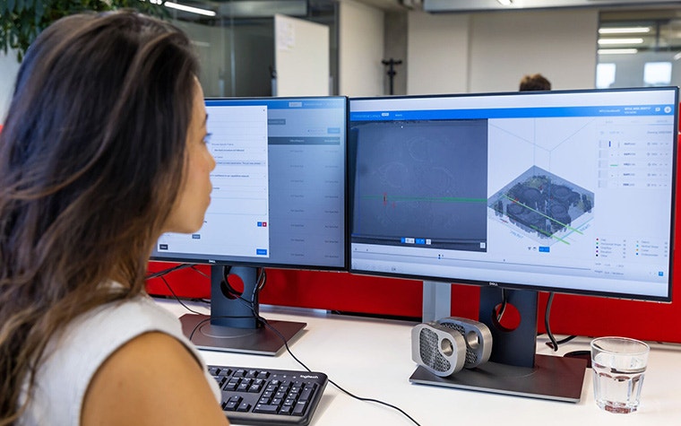 Woman looking at CO-AM software on a computer screen