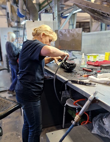 A member of the Materialise production team using a tool to finish a vacuum-cast part in our production facilities in the Czech Republic