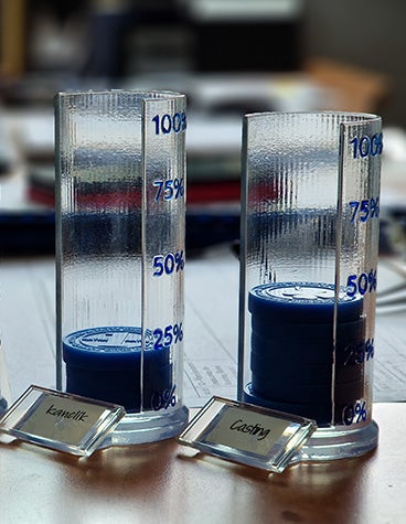 Containers that hold 3D-printed Matak coins for each office in Materialise's Czech office