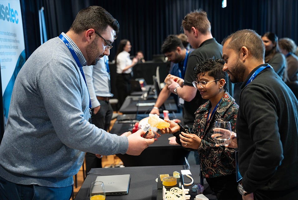 A Materialise employee showing a 3D-printed anatomical model to attendees during the 3D Printing in Hospitals Forum 2024
