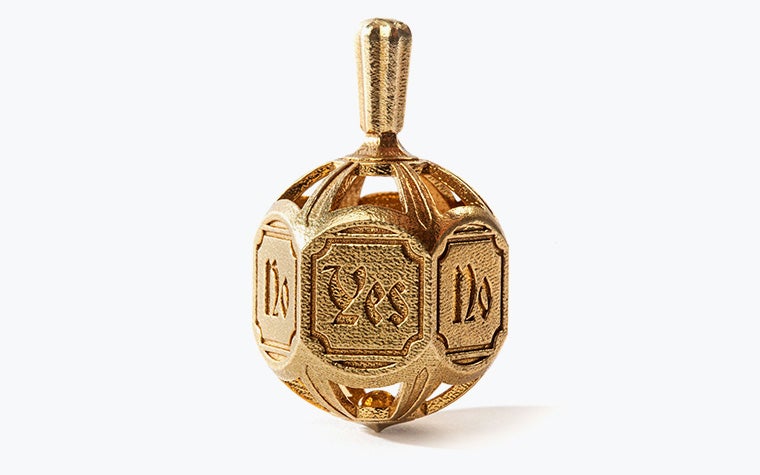 A detailed decision-making spinning top embossed with the words "yes" and "no". Made in brass using lost-wax casting.