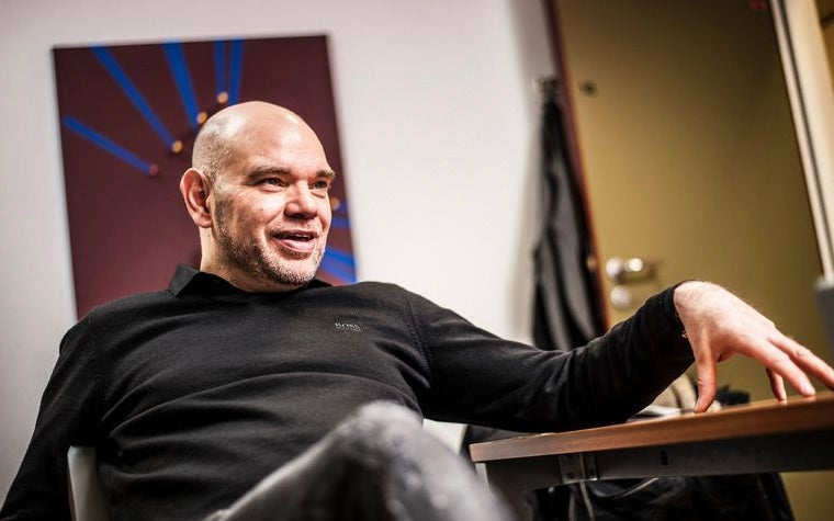 Stefaan de Nijs sitting down with his hand on a table