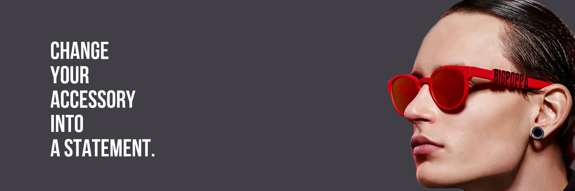 Model wearing red sunglasses that say Big Poppa