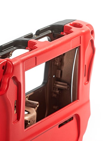 Close-up view of a red and black part of a portable crack detector, vacuum casted using the ABS-like polyurethane material