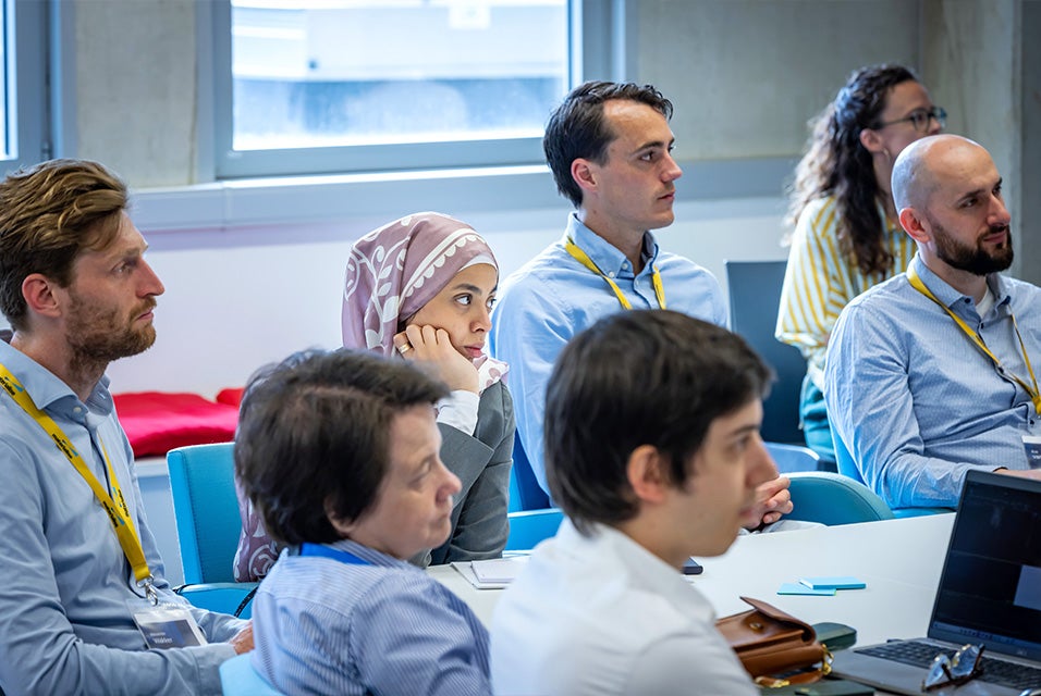 3D Planning and Printing in Hospitals Forum attendees sitting at a table in a training room, attentively listening to a presentation.