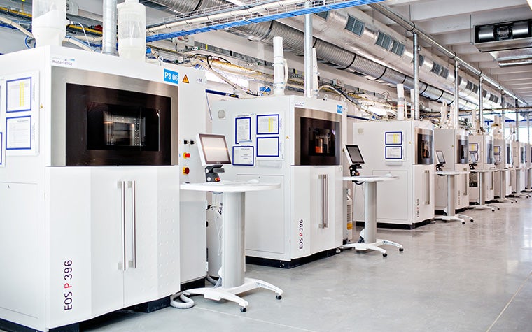 A row of EOS 3D printers in Materialise&#x27;s 3D printing facilities