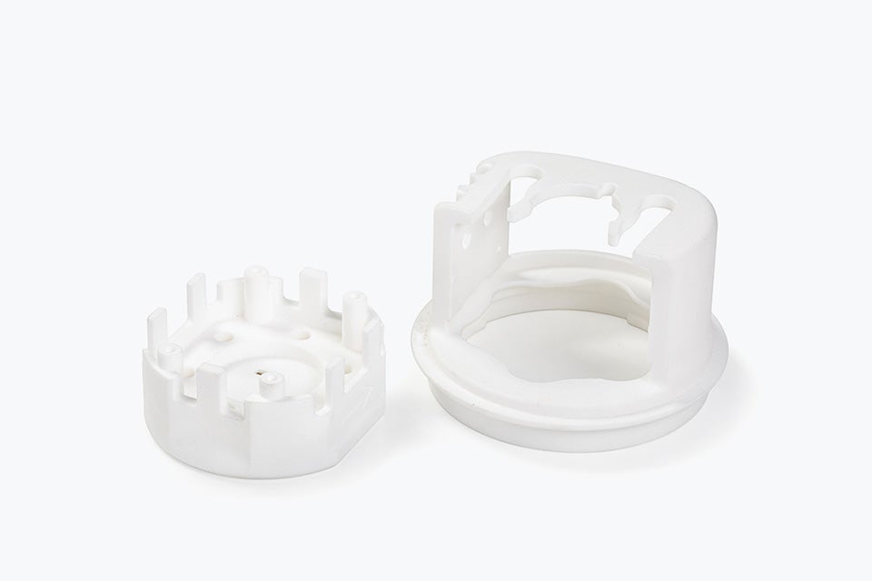 A white 3D-printed tool made in PA 12 Medical-Grade using selective laser sintering.
