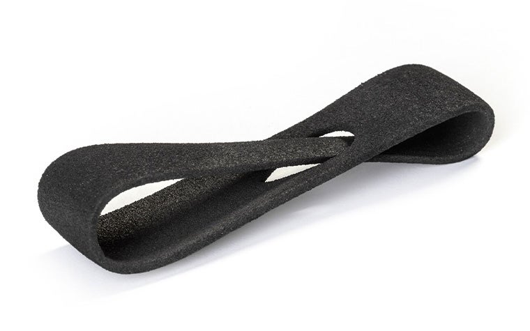 A black 3D-printed loop made from Ultrasint TPU 90A-01 using Multi Jet Fusion, with a normal finish.