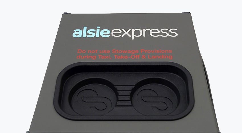 Stirling Dynamic's cube-like seat blocker, featuring handcrafted grey/green leather and a black 3D-printed insert in the top side for smartphones and other devices.