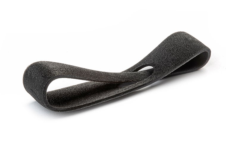 A black 3D-printed loop made from Agilus using PolyJet, with a basic finish.
