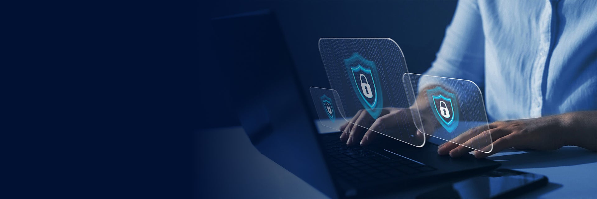 Person with their hands on a laptop and graphics of secure locks floating in front of the computer