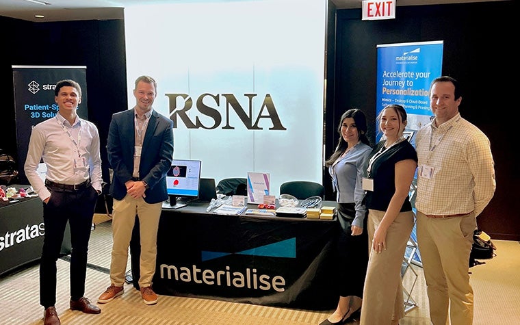 The Materialise team posing at their booth during the RSNA event.