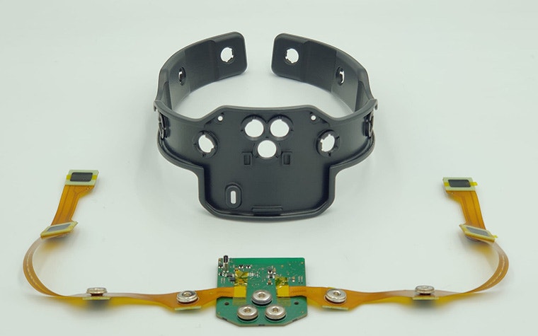 The inside of the NeuroPlay EEG headset, 3D-printed to fit and protect the electronics laid in front of it.