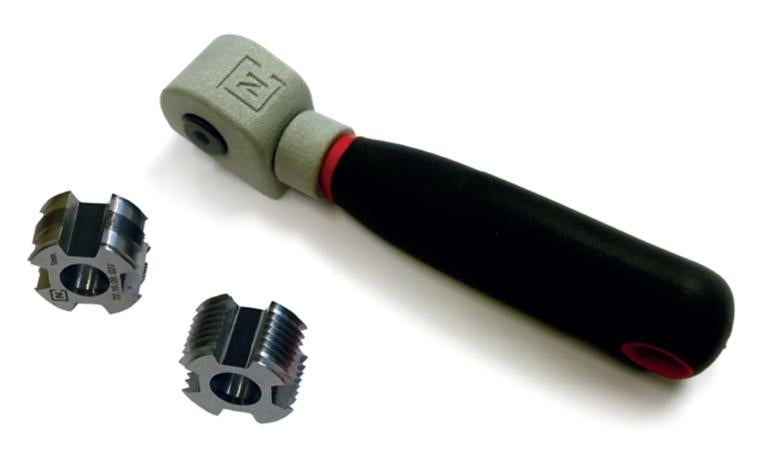 Neurtek's cutting tool, featuring a 3D-printed oscillating head made from PA-AF, next to two sets of blades.