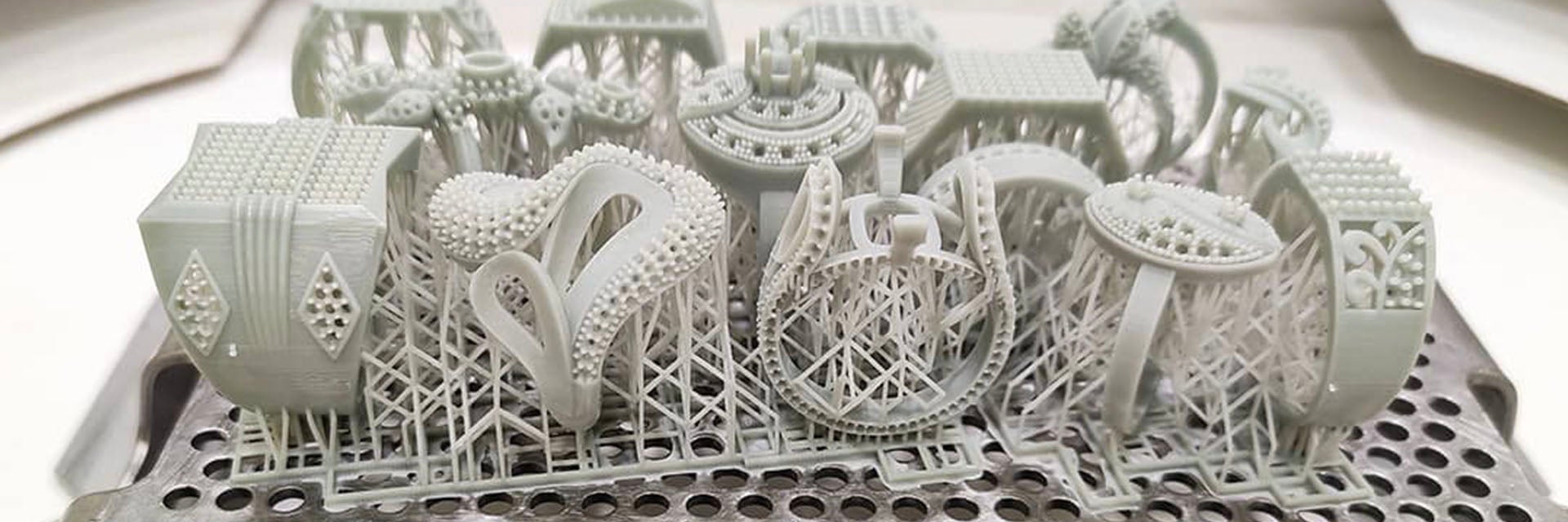 3D-printed jewelry on a build plate with support structures