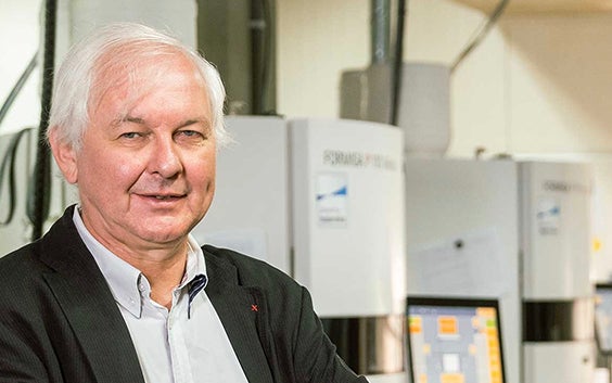 Fried Vancrean, CEO of Materialise, standing in front of several 3D printers.
