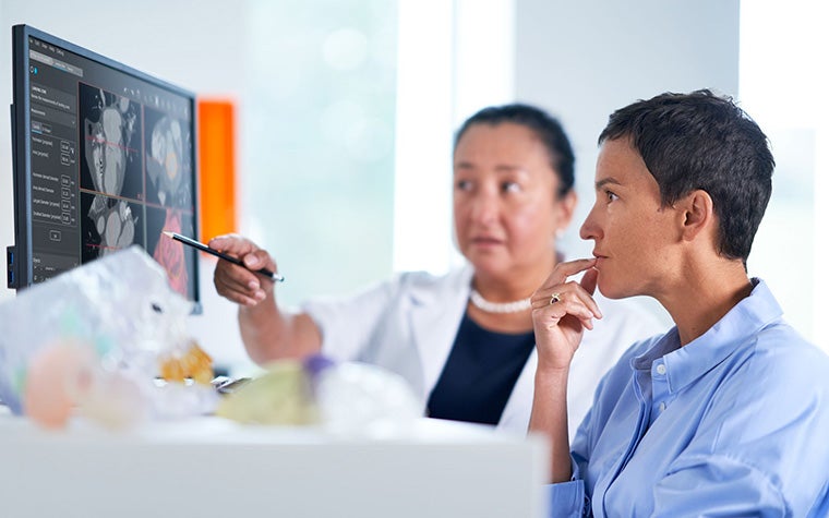 Two people checking software for 3D planning