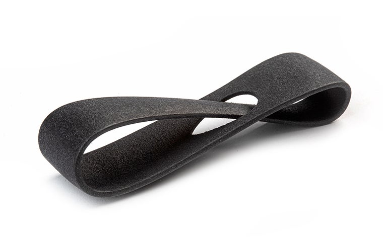 A black 3D-printed loop made from PA12 (MJF) using Multi Jet Fusion, with a smooth and color-dyed finish.