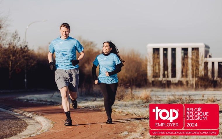 Two Materialise employees running on a path