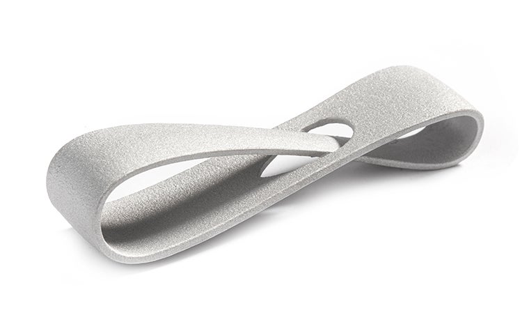 A metal 3D-printed infinity loop made from aluminum using selective laser melting. The loop has a matt finish, achieved through corundum blasting.