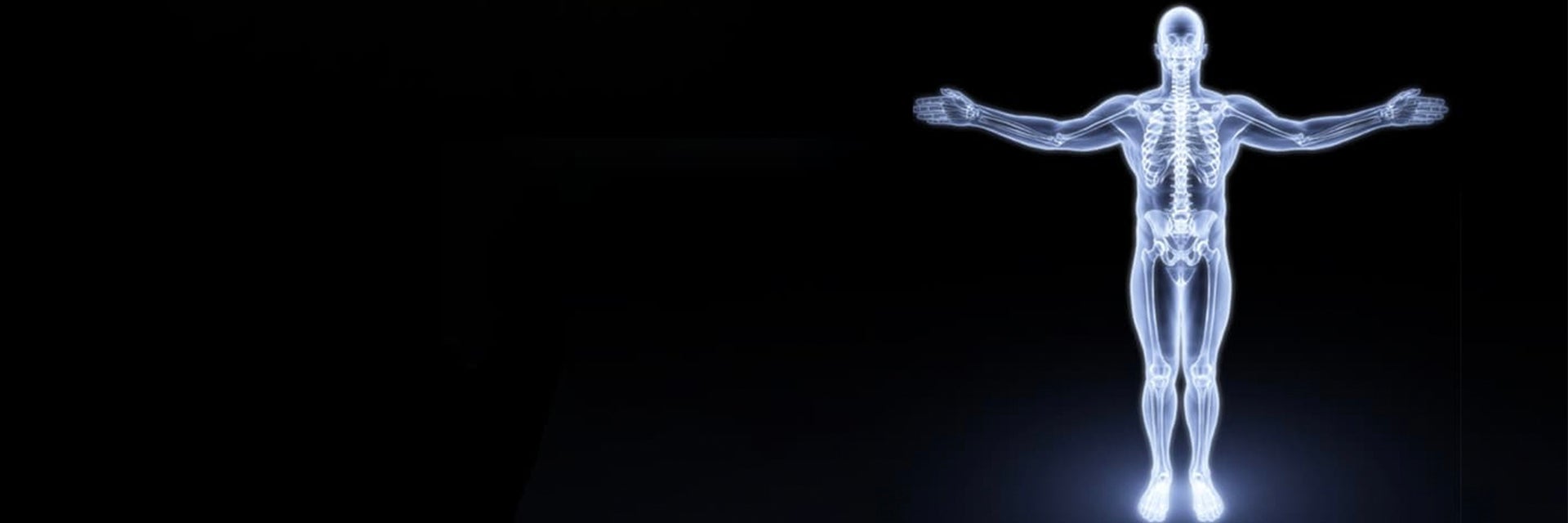 Image of a person standing with their arms spread and their skeleton glowing through