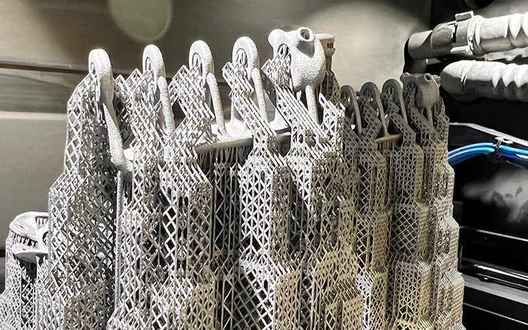 A close up of the titanium pulley system being supported by needle-thin support structures generated by e-Stage for Metal+