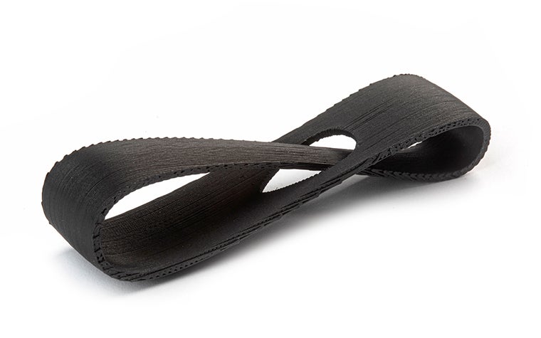 A black 3D-printed loop made from ABS-M30 using fused deposition modeling, finished with matte paint and a 10 percent gloss.