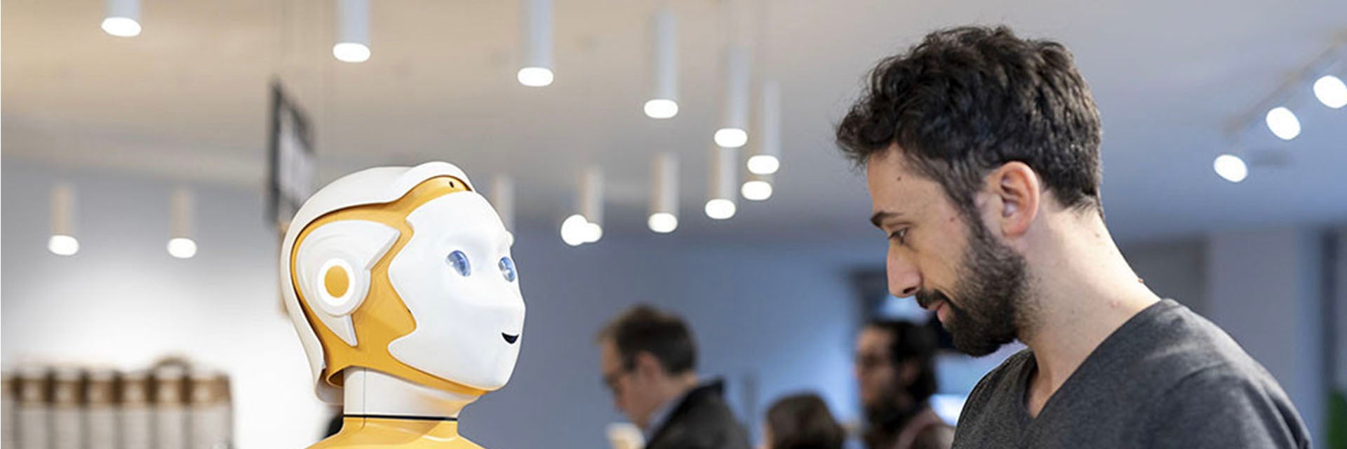 Man using touchscreen on the chest of the ARI robot