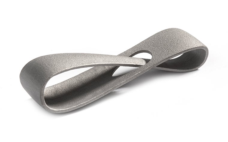 A metal 3D-printed infinity loop made from titanium using selective laser melting. The loop has a matt finish, achieved through corundum blasting.