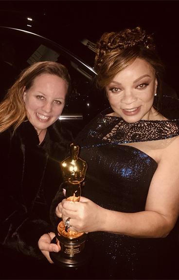 Ruth Carter and Julia Koerner holding an Oscar award