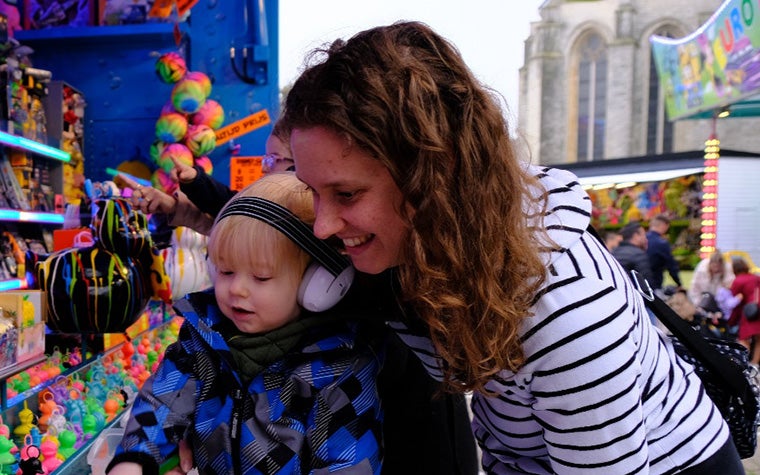 A woman (Tem Bertels) is with her son at an amusement park.