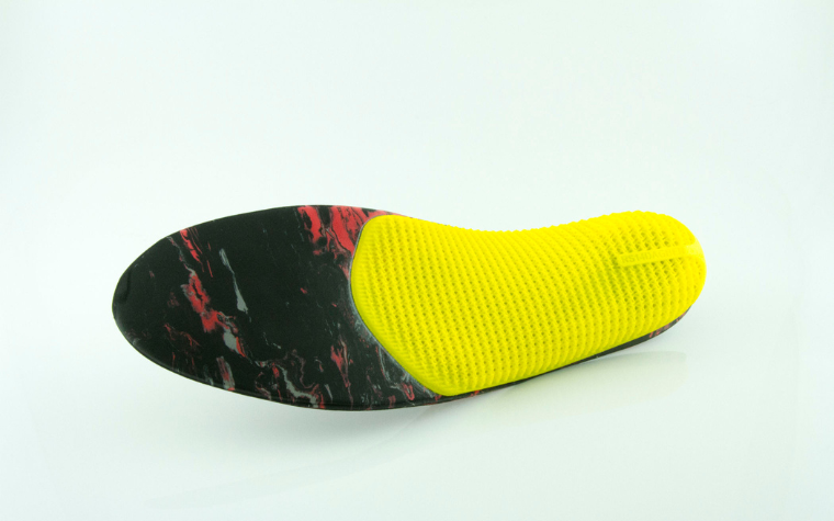 An early model of 3D-printed phits orthotics with a bright yellow base.