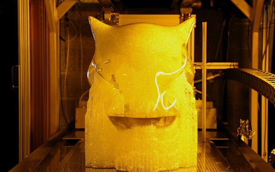 The 3D-printed jaguar's head emerging from the printing process