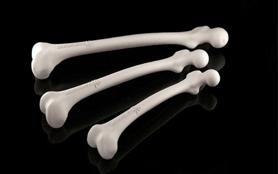 Three 3D-printed bone models with the Materialise logo on them