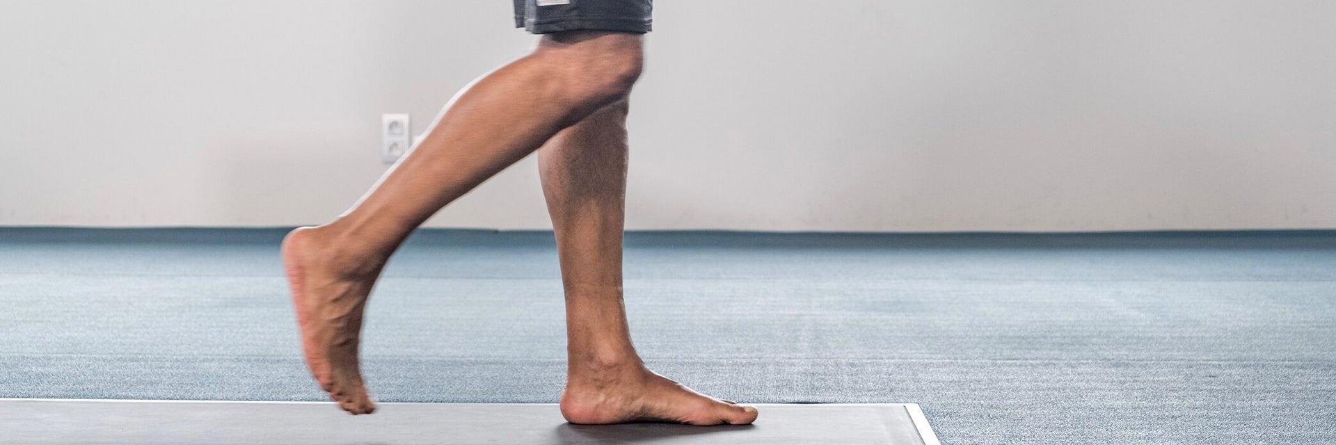 Man walking over a pressure plate in bare feet