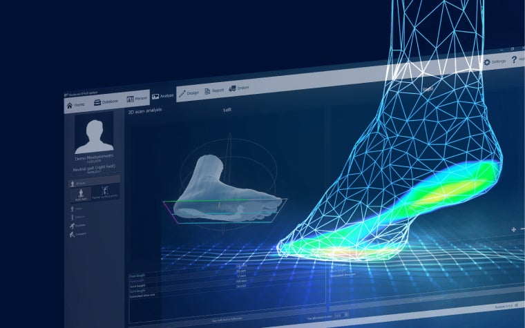 A computer-generated 3D image of a human foot and ankle with a glowing sole emerging from a computer screen showing orthotic design software.