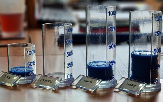 Containers that hold 3D-printed Matak coins for each office in Materialise's Czech office