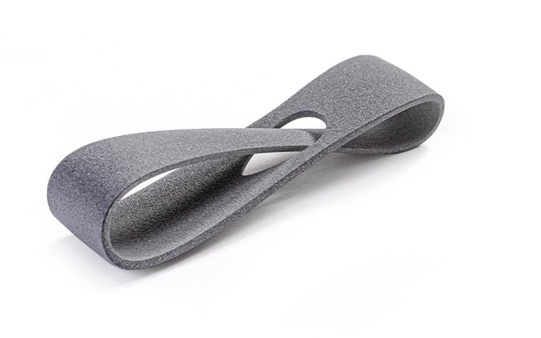 A gray 3D-printed loop made in PA 12S using Multi Jet Fusion with a normal finish.