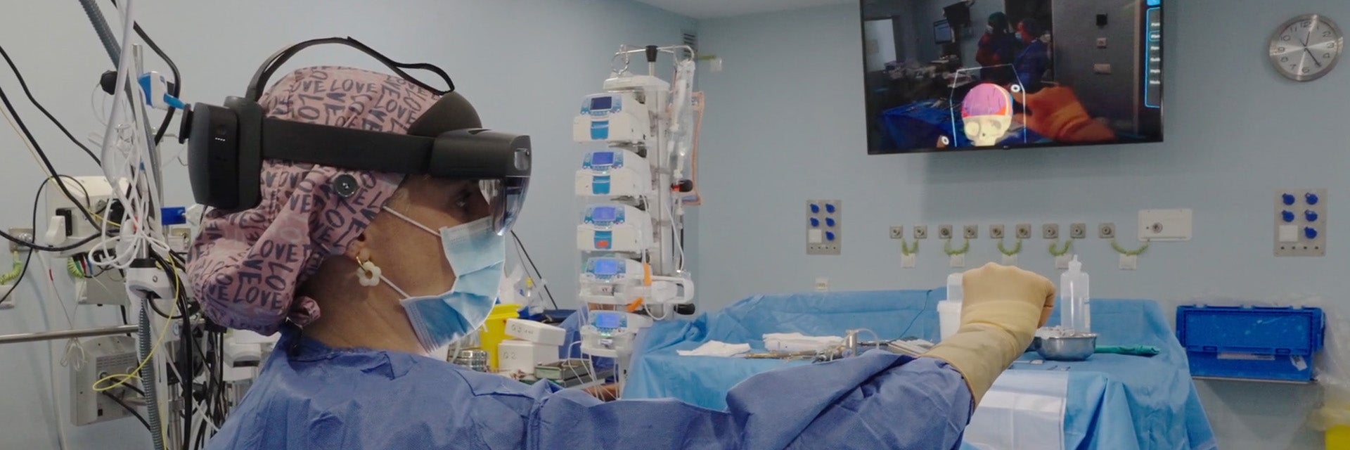 A surgeon wearing augmented reality goggles, reviewing a 3D anatomical model in the operating room