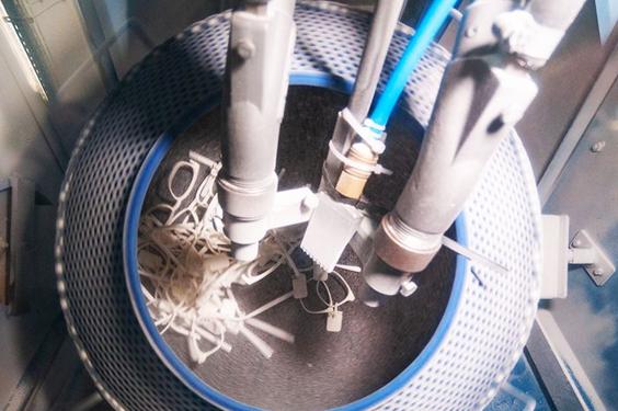 Vat of eyewear in post-processing at Materialise production