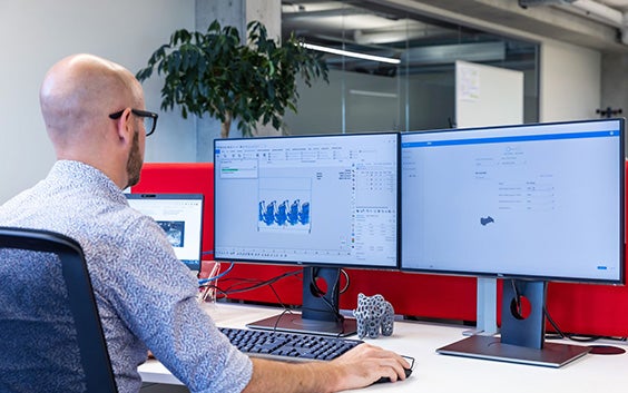 A man using a desktop PC with Load Balancer software.