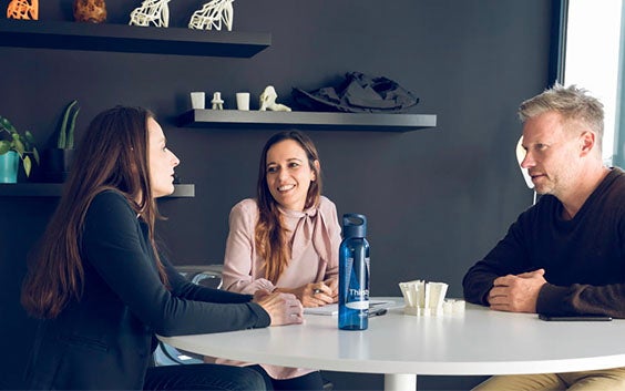 Group of people sitting at a table and talking