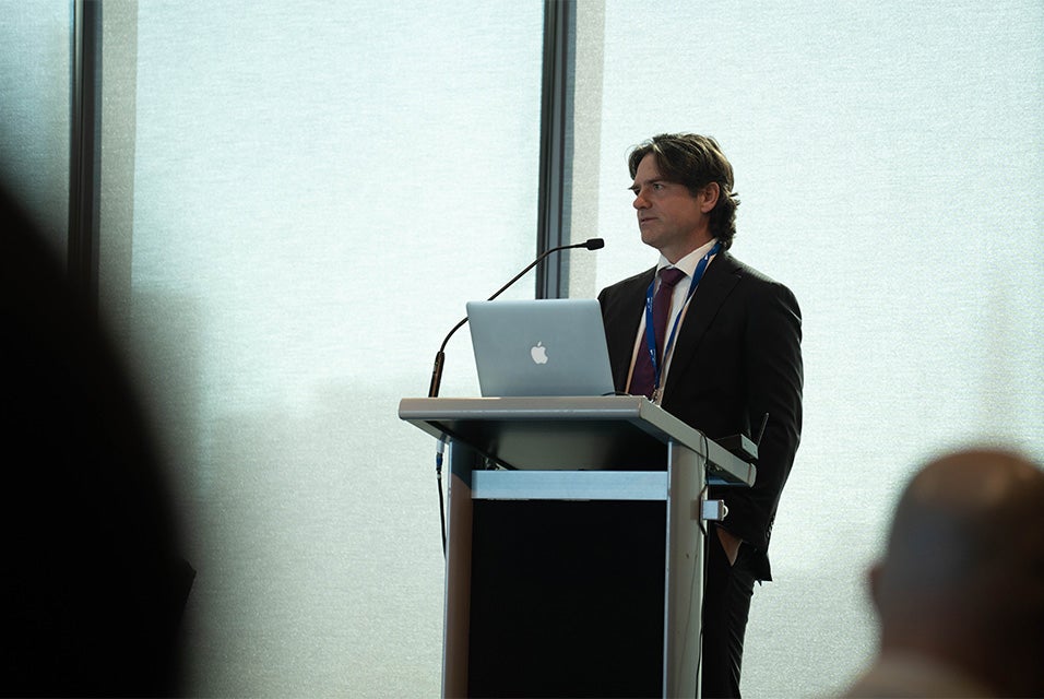 Keynote speaker Dr. Michael Wagels at a podium during the 3D Printing in Hospitals Forum 2024