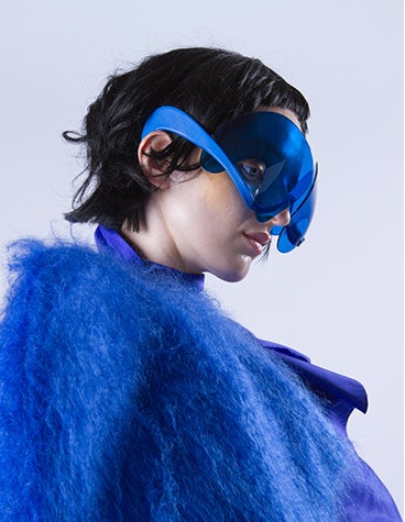 A woman wearing blue Dávid Ring's 3D-printed luxury glasses