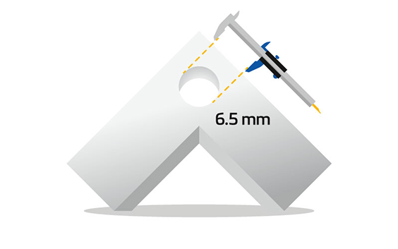 A three-dimensional angular shape resembling an upward-pointing arrow with a circular hole near the top, being measured with calipers showing a diameter of 6.5 mm.