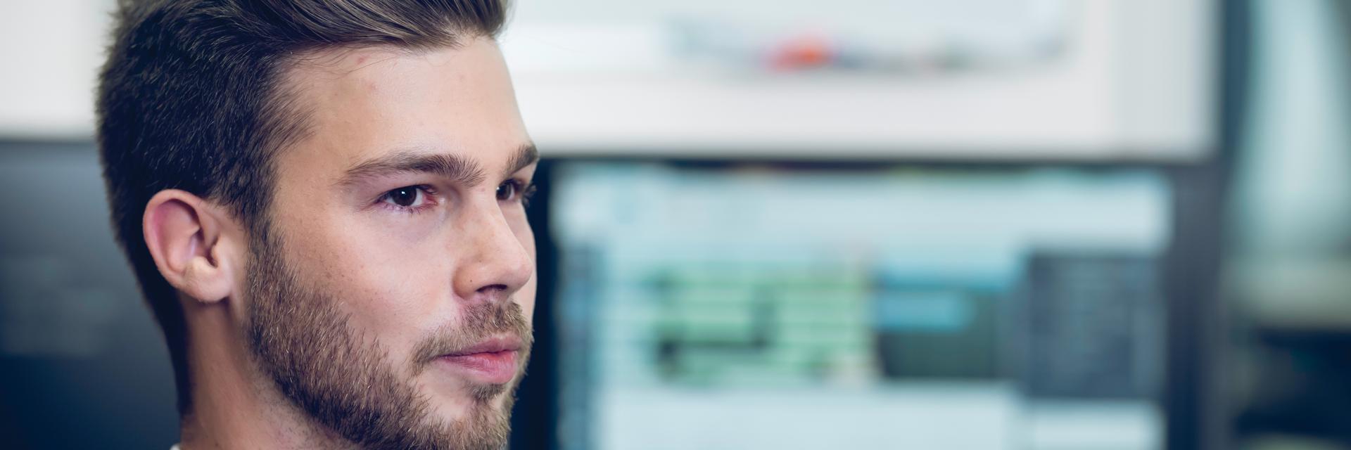Man looking away from a screen with Streamics on it
