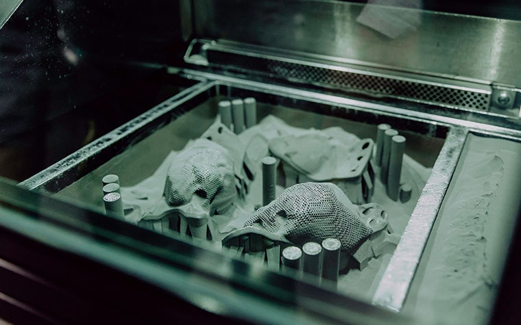 Metal 3D-printed hip implants in the powder bed of a 3D printer