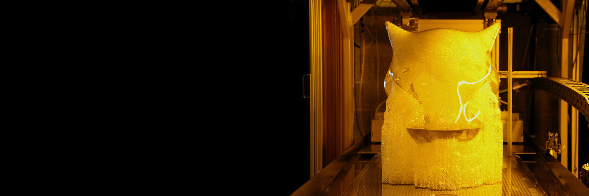 The 3D-printed jaguar's head emerging from the printing process