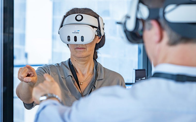 A woman wearing a virtual reality headset at the Materialise CMF Innovation Summit.