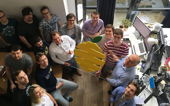 Lemon team holding a large image of a lemon